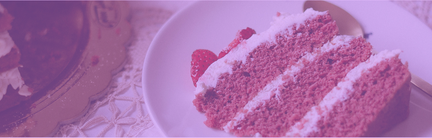 Close up of a delicious pink strawberry cake on a lace tablecloth